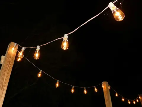 String lights glowing over the venue at night