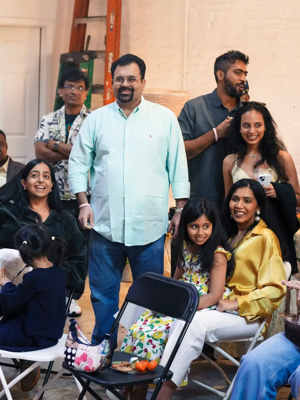 A family gathered together indoors, smiling